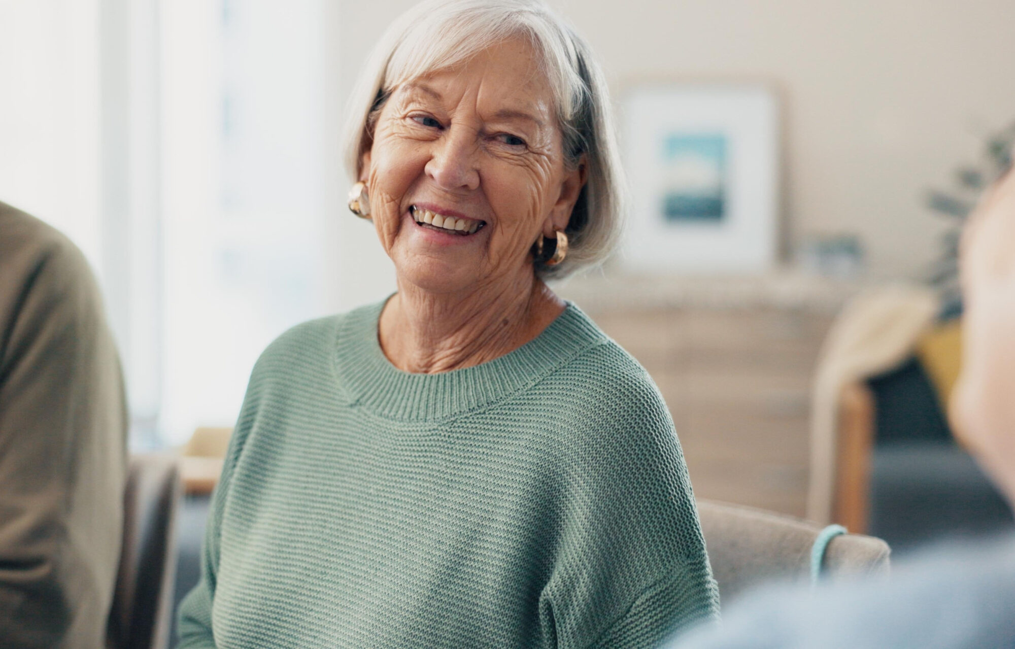 Home,,Happy,Friends,And,Senior,Woman,Relax,,Conversation,And,Bonding Home, happy friends and senior woman relax, conversation and bonding in lounge. Elderly, pensioner and group of people smile in living room for chat, funny and laughing together in retirement house